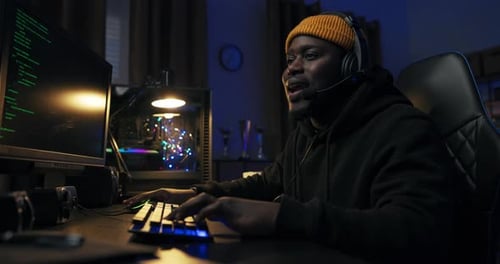 Young Adult Typing at Night on Computer Keyboard