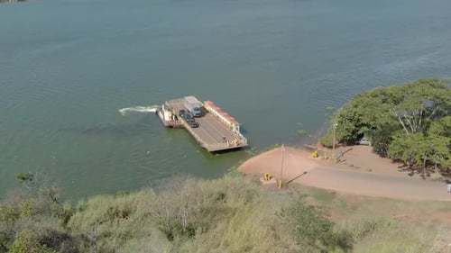 Boat crosses cars from one side of the river to the other. Transport ferry