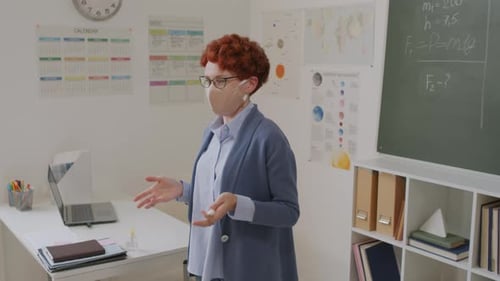 Female Teacher Lecturing in Classroom with Face Mask