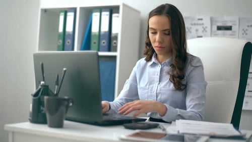 Beautiful Businesswoman Working on Her Laptop While Sitting at Office