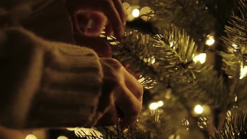 Decorating Christmas Tree with Ornament and Lights