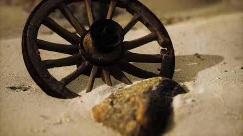 Old Wooden Wagon Wheel on Desert Sand