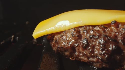 Time Lapse of Cheese Melting on Burger Meat on Grill