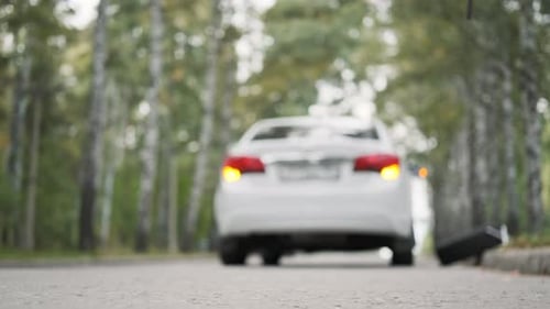 Hand of Man Putting Triangle By the Broken Car