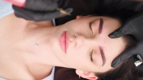 Woman Receiving Eyebrow Microblading Treatment Close Up