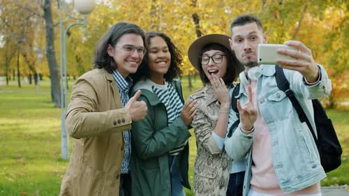 Laughing Young People Friends Taking Selfie in Park with Smartphone Camera