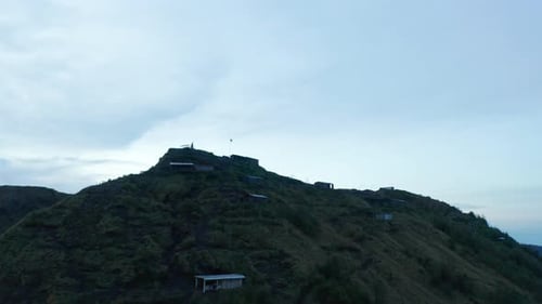 Close Up Aerial Shot of Scattered Residential Houses and Farms at the Top of the Mountain Peak of