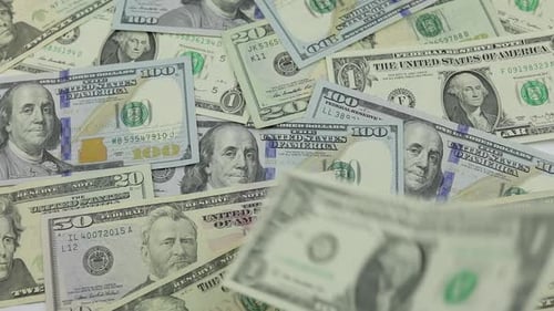 Dollar Bills Fall on the Table with American Dollars of Different Denominations