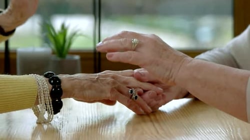 Elderly Women Holding Hands