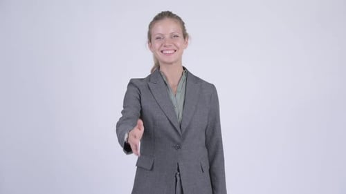 Young Happy Blonde Businesswoman Giving Handshake