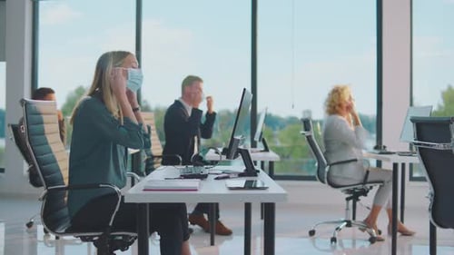 Employees Working at Desks in Modern Office Setting