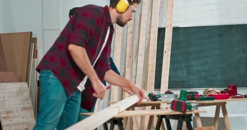 Two Young Men Crafting Wood in Workshop