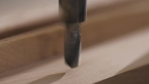 Drill Bit Boring Into Wood in Close Up