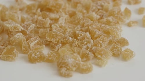 Tilting over cooked and candied ginger root on the table 4K 2160p 30fps UltraHD footage - Crystalli