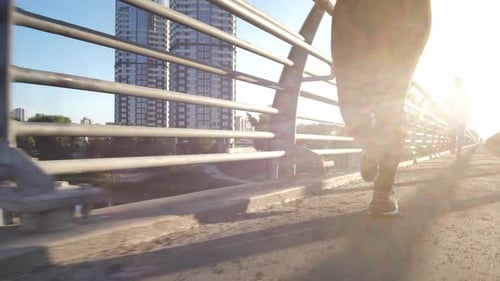 Two Women Jogging on Bridge on Sunny Day