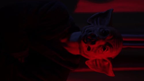 Close Up of Spooky Creature Mask Lit in Red