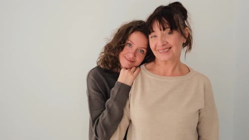 Affectionate Mother and Daughter Embracing Indoors