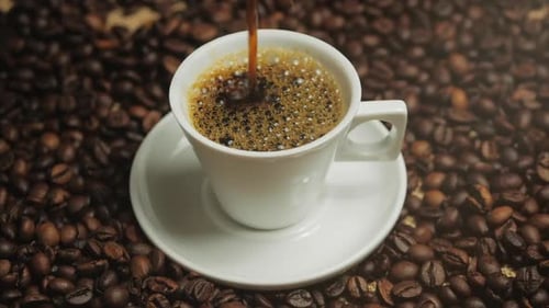Coffee Cup and Coffee Beans. White Cup of Evaporating Coffee on the Table with Roasted Bean. Stock