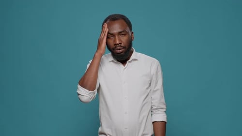 Man Experiencing a Headache in Studio