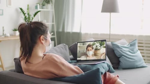Young Woman Video Chats on Laptop at Home