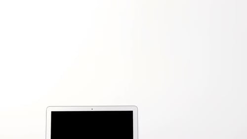 Laptop with diary and pen on table