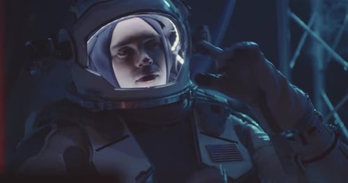 Astronaut Checks Equipment in a Futuristic Space Station