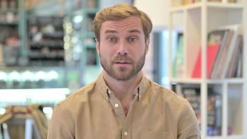 Adult Man Points Finger at Camera