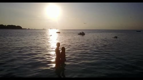 Man and lady sunbathing on exotic shore beach voyage by shallow sea and white sandy background of th