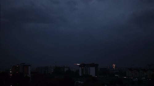 Cityscape at Night Under Ominous Clouds