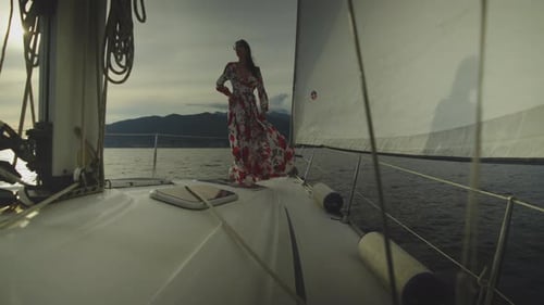 Woman Posing on Sailboat at Sunset
