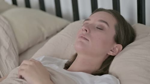 Woman Sleeping Peacefully in Bed at Home