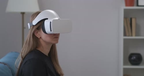 Woman Uses Virtual Reality Headset at Home