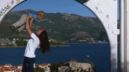 Mother and Child Playing near the Ocean View