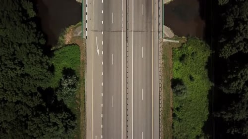 Top Down Close Up Fly Over Road, Asphalt, White Arrow Signs Indicating Direction, Way of the Highway