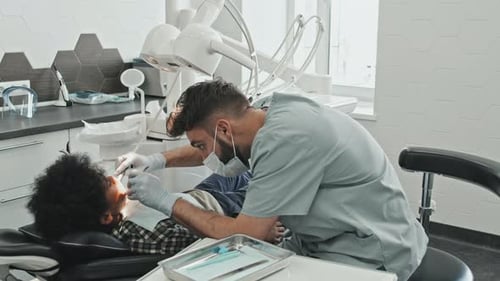 Dentist Working on Child Patient in Modern Clinic