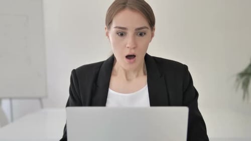Close Up of Shocked Young Businesswoman Wondering at Work