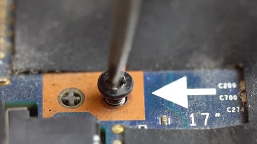 Black Screw Removed from Computer Circuit Board