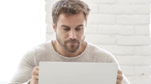 Man Working on Laptop in Modern Home Office