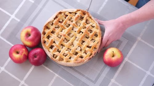 Apple Pice Cake Preparation Series Woman Slicing Pie on a Table Top View
