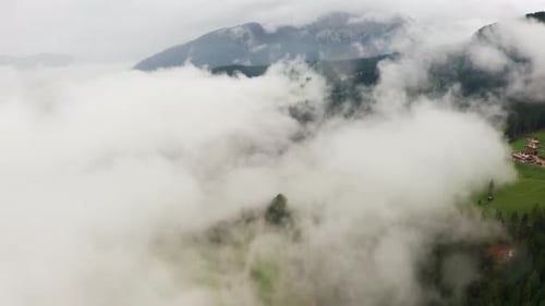 Motion Through Large White Cloud Near Alps Mountain Slope
