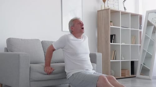 Senior Man Experiences Pain While Doing Tricep Dips