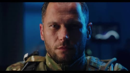 Determined Man in Camouflage Stares Intensely