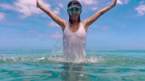 Joyful Woman Emerging from the Ocean Waves