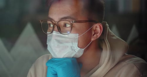 Young Adult Wearing Mask and Gloves Close Up