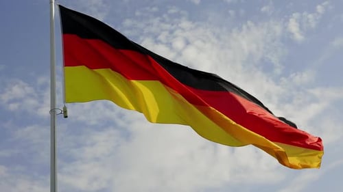 German Flag Waving Against Blue Cloudy Sky