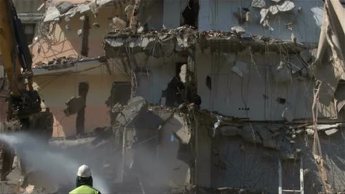 Excavator Demolishing Damaged Building on Sunny Day
