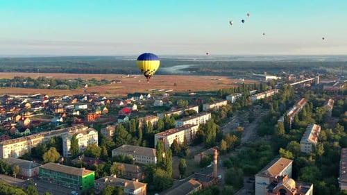 Hot Air Balloons Fly Over Suburban Neighborhood