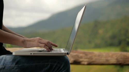 Typing on Laptop Computer Outdoors in Nature