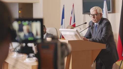 Mature Man Giving Speech at Podium