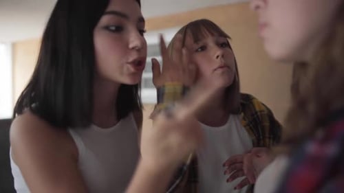 Three Young Women Chatting Indoors